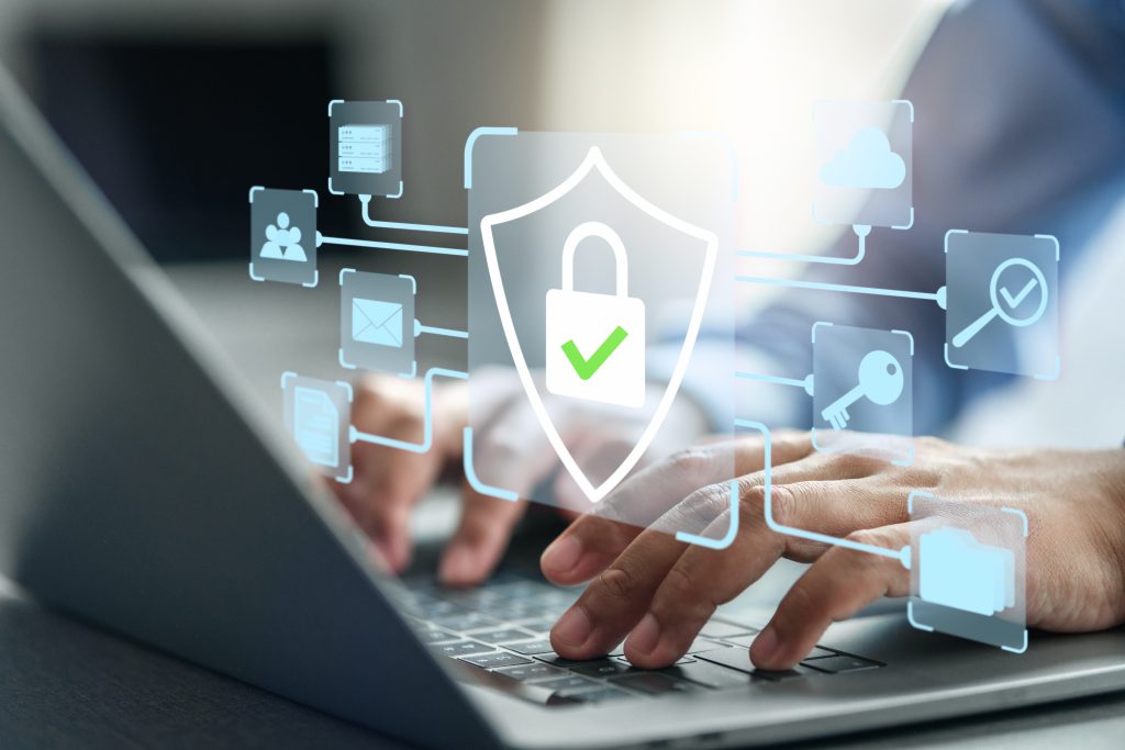 Cybersecurity professional working on a computer with a digital lock security icon overlay